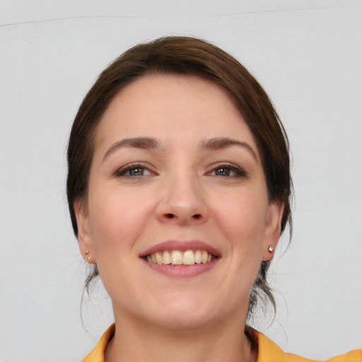 Joyful white young-adult female with medium  brown hair and brown eyes