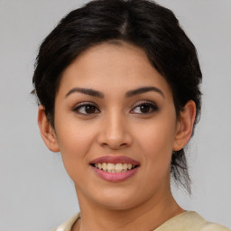 Joyful latino young-adult female with medium  brown hair and brown eyes