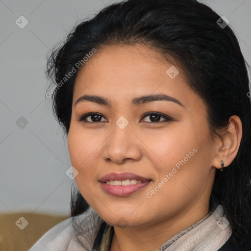 Joyful latino young-adult female with long  brown hair and brown eyes