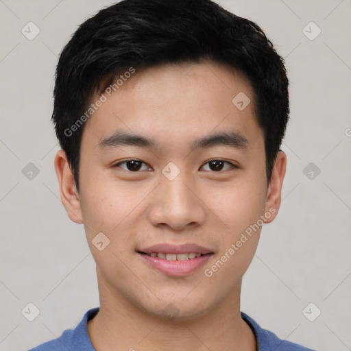 Joyful asian young-adult male with short  brown hair and brown eyes