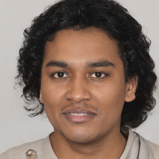 Joyful black young-adult male with short  black hair and brown eyes