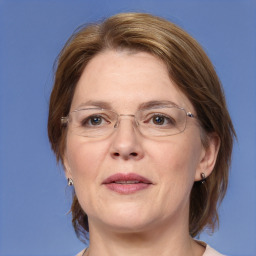 Joyful white adult female with medium  brown hair and blue eyes