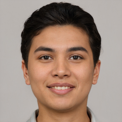 Joyful asian young-adult male with short  brown hair and brown eyes