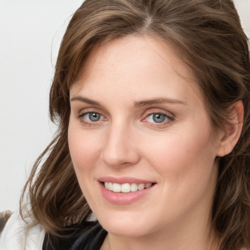 Joyful white young-adult female with medium  brown hair and blue eyes