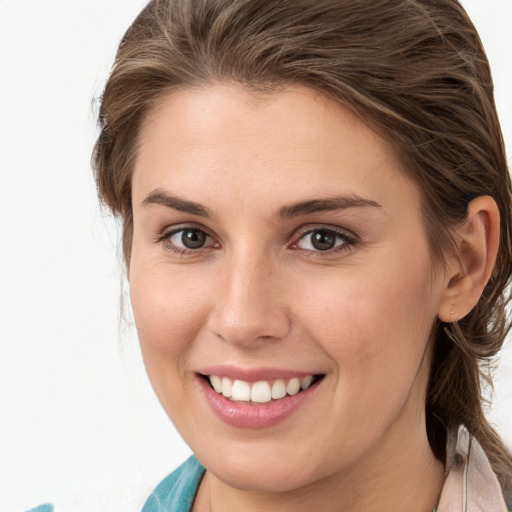 Joyful white young-adult female with medium  brown hair and grey eyes