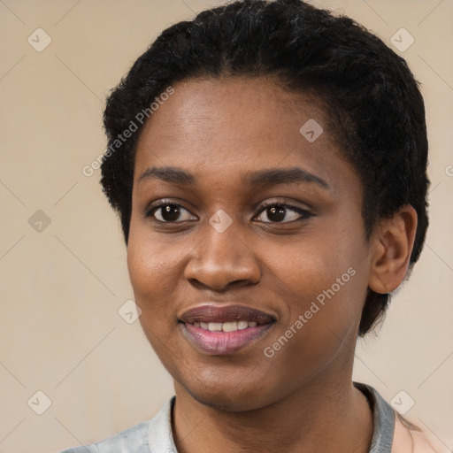 Joyful black young-adult female with short  black hair and brown eyes