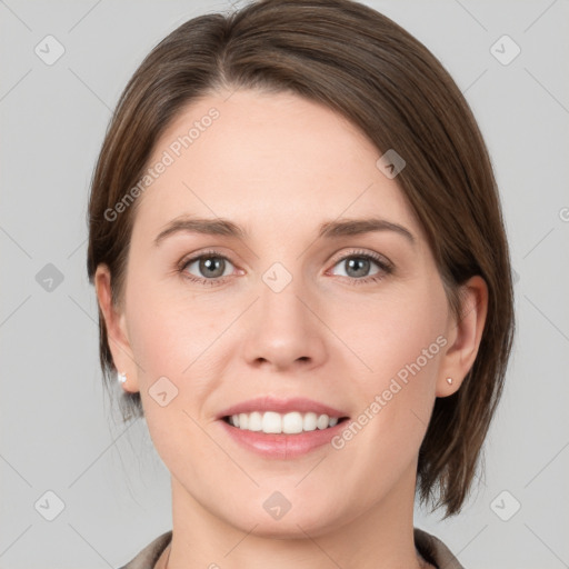 Joyful white young-adult female with medium  brown hair and grey eyes