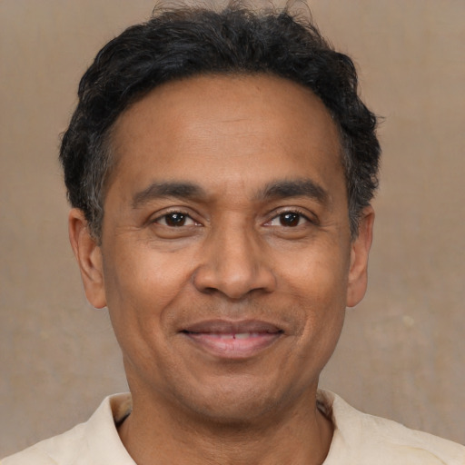 Joyful latino adult male with short  brown hair and brown eyes