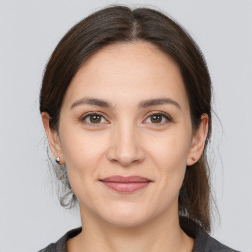 Joyful white young-adult female with medium  brown hair and brown eyes