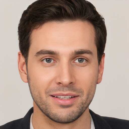 Joyful white young-adult male with short  brown hair and brown eyes