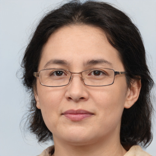 Joyful white adult female with medium  brown hair and brown eyes