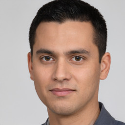 Joyful white young-adult male with short  black hair and brown eyes