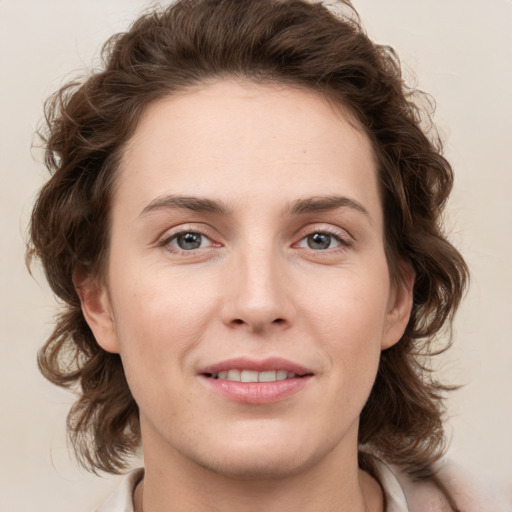 Joyful white young-adult female with medium  brown hair and green eyes