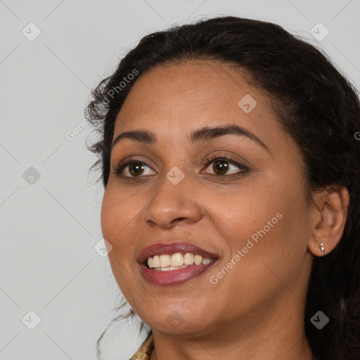 Joyful black adult female with long  brown hair and brown eyes