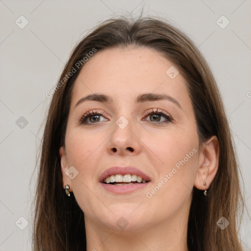 Joyful white young-adult female with long  brown hair and grey eyes