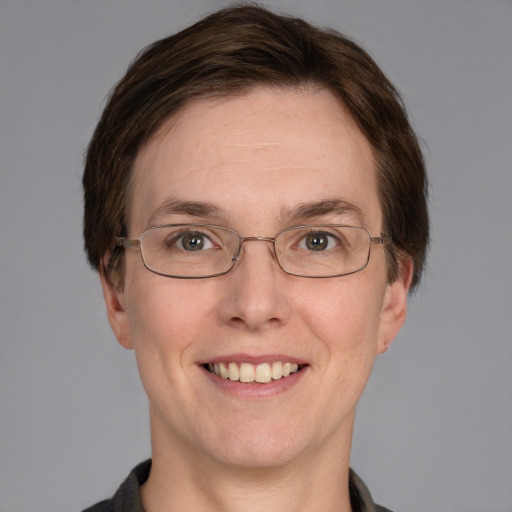 Joyful white adult female with short  brown hair and grey eyes