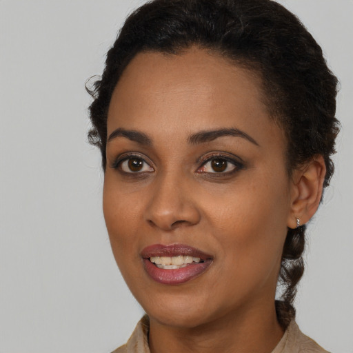 Joyful black young-adult female with medium  brown hair and brown eyes