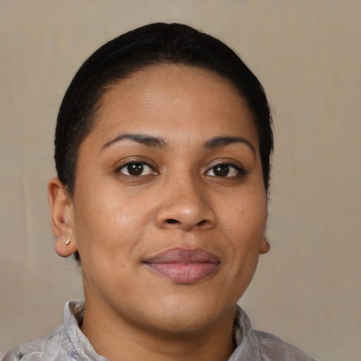Joyful latino young-adult female with short  brown hair and brown eyes