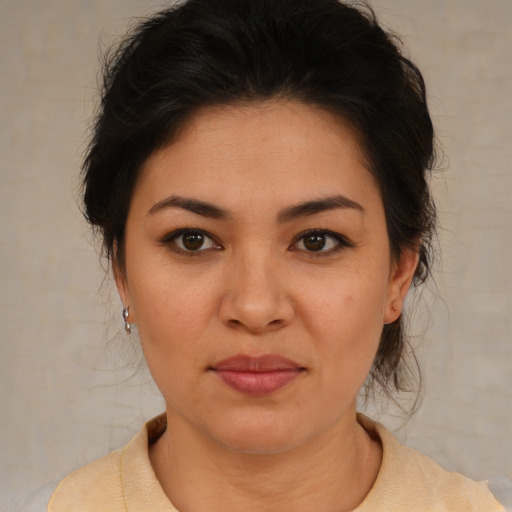 Joyful latino young-adult female with medium  brown hair and brown eyes