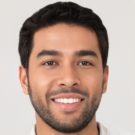 Joyful white young-adult male with short  black hair and brown eyes