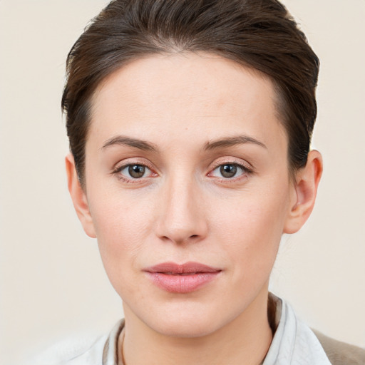 Joyful white young-adult female with short  brown hair and brown eyes