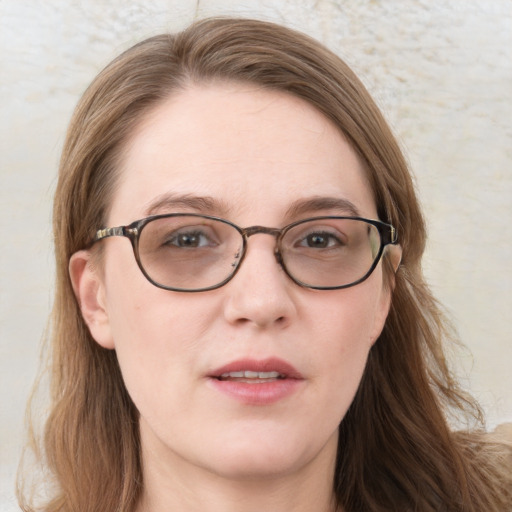 Joyful white young-adult female with long  brown hair and blue eyes