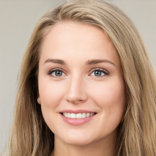 Joyful white young-adult female with long  brown hair and green eyes