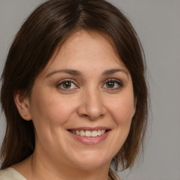 Joyful white adult female with medium  brown hair and brown eyes