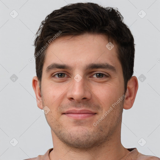 Joyful white young-adult male with short  brown hair and brown eyes