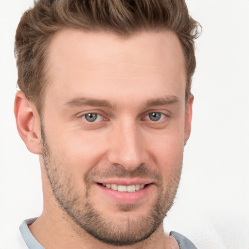 Joyful white young-adult male with short  brown hair and grey eyes