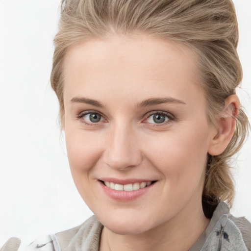 Joyful white young-adult female with medium  brown hair and blue eyes