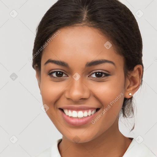 Joyful latino young-adult female with long  brown hair and brown eyes