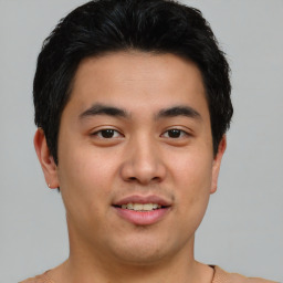 Joyful asian young-adult male with short  brown hair and brown eyes