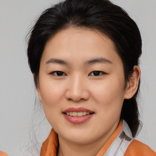 Joyful asian young-adult female with medium  brown hair and brown eyes
