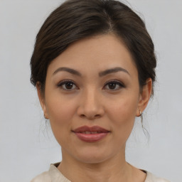 Joyful asian young-adult female with medium  brown hair and brown eyes