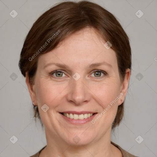 Joyful white adult female with medium  brown hair and grey eyes