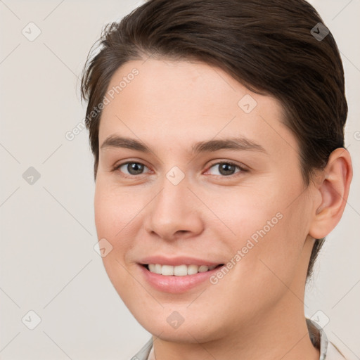 Joyful white young-adult female with short  brown hair and brown eyes