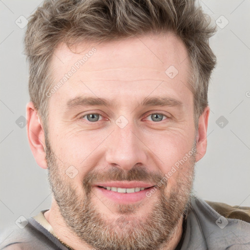 Joyful white adult male with short  brown hair and grey eyes