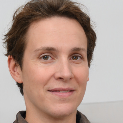 Joyful white adult female with short  brown hair and grey eyes