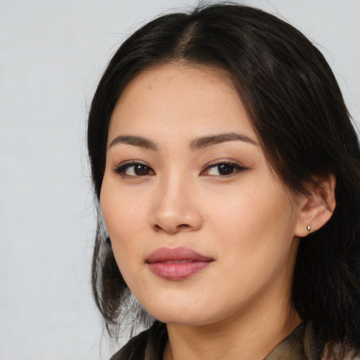Joyful asian young-adult female with long  black hair and brown eyes