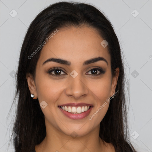 Joyful latino young-adult female with long  brown hair and brown eyes