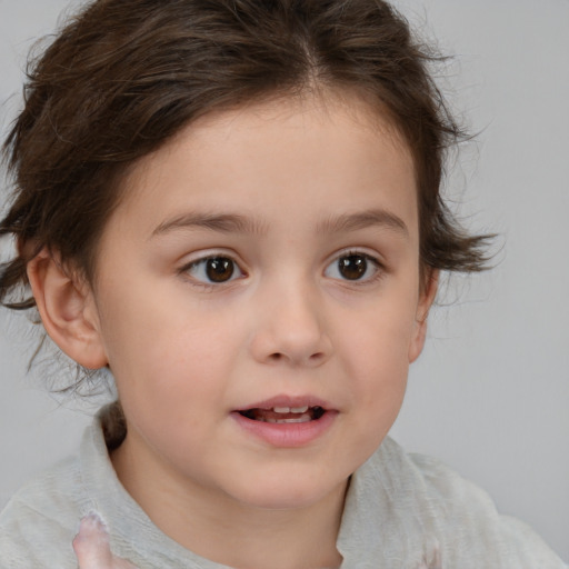 Joyful white child female with short  brown hair and brown eyes