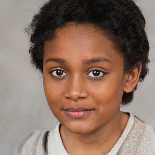 Joyful black child female with medium  brown hair and brown eyes