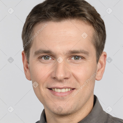 Joyful white adult male with short  brown hair and grey eyes