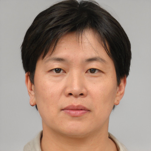 Neutral asian adult male with short  brown hair and brown eyes