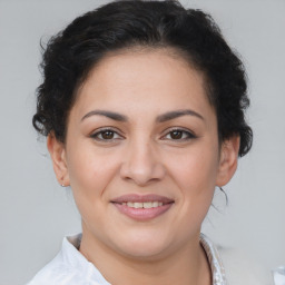 Joyful latino young-adult female with medium  brown hair and brown eyes