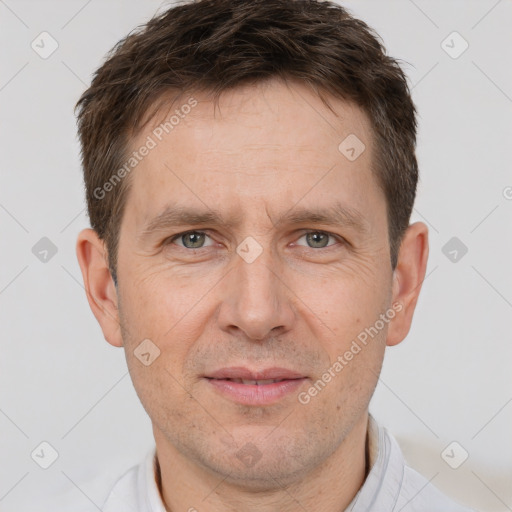 Joyful white adult male with short  brown hair and brown eyes