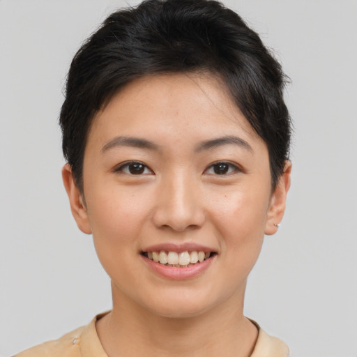 Joyful asian young-adult female with short  brown hair and brown eyes