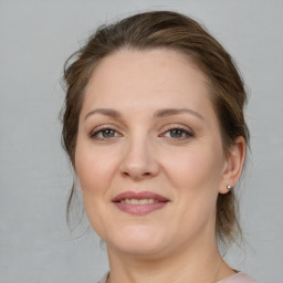 Joyful white adult female with medium  brown hair and brown eyes