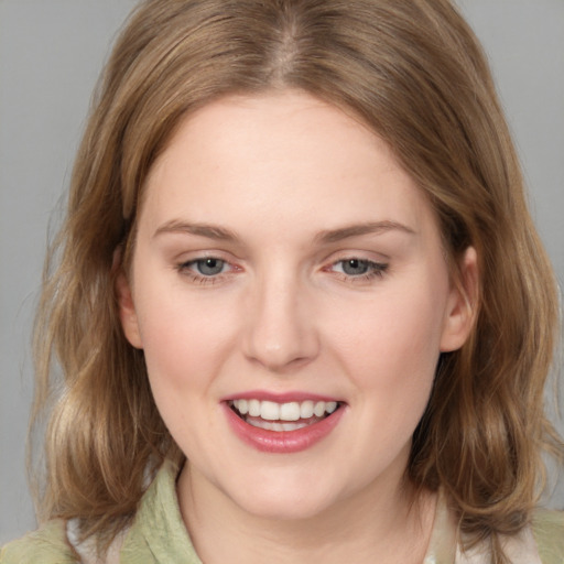 Joyful white young-adult female with medium  brown hair and blue eyes